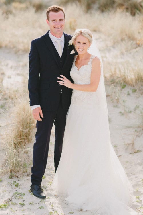 Real Weddings | Vinka Design | Real Brides Wearing Vinka Gowns | Louise and Ryan smiling portrait in sand dunes