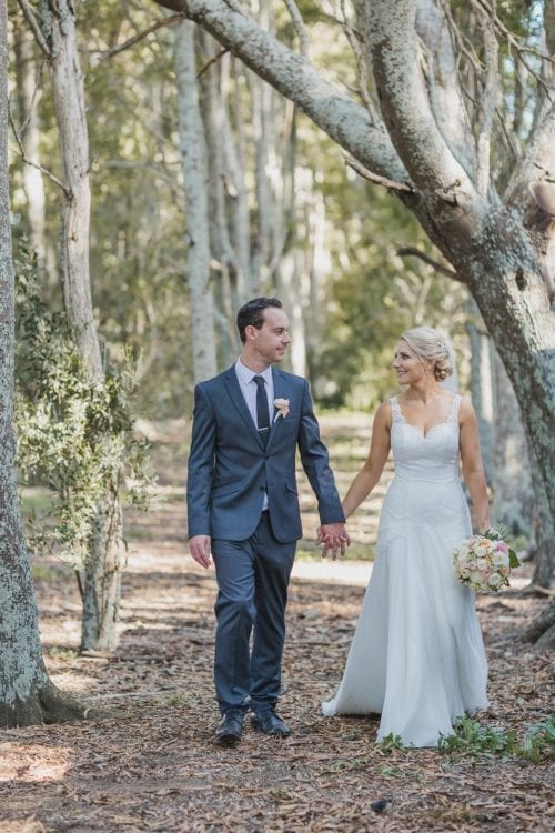 Real Weddings | Vinka Design | Real Brides Wearing Vinka Gowns | Sophie and Auldan walking through forest path