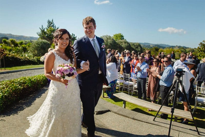 Testimonials | Vinka Design | Real Bridal Reviews from Our Clients | Ayesha and husband with guests behind them just married