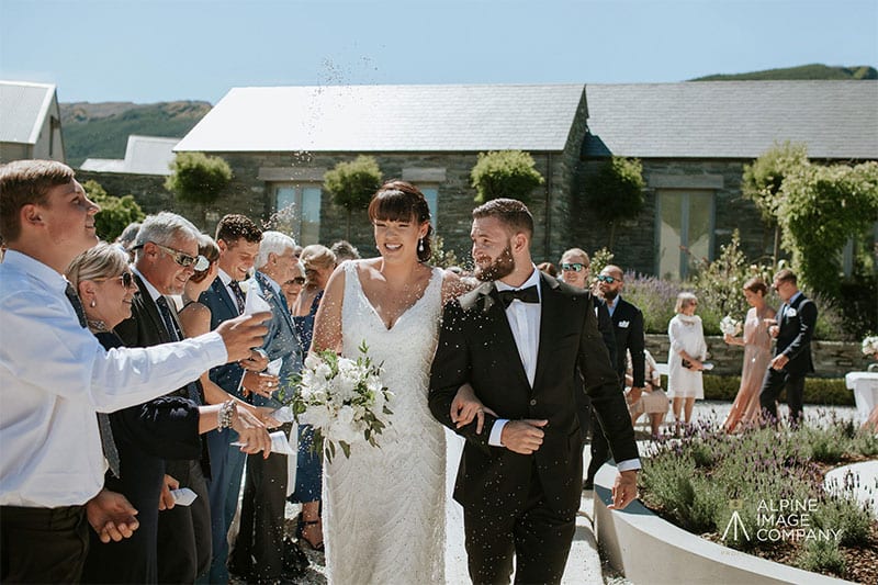 Testimonials | Vinka Design | Real Bridal Reviews from Our Clients | Danielle and Nick walking down aisle just married in bespoke gown