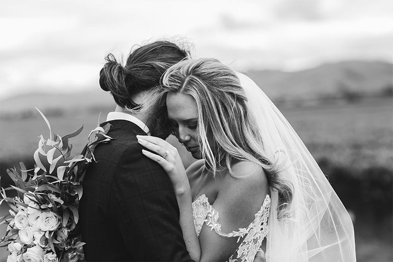 Testimonials | Vinka Design | Real Bridal Reviews from Our Clients | Olivia and Brayden embracing in black and white