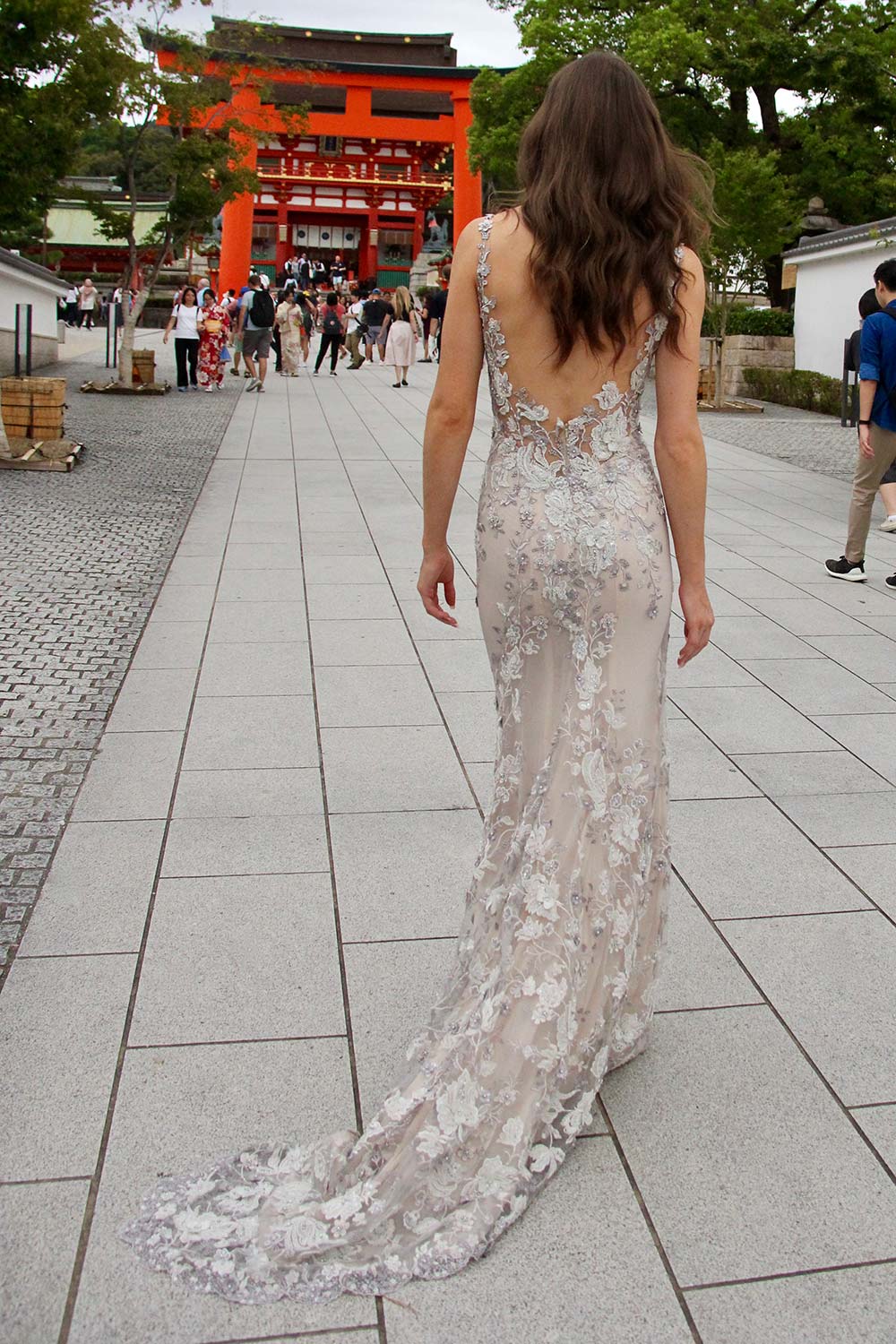 Female model wearing Vinka Design An Oriental Affair Wedding Dress. At a japanese temple in Kyoto the back detail of a slender silhouette form-fitting gown with a low sheer back, deep v-neckline and thin straps