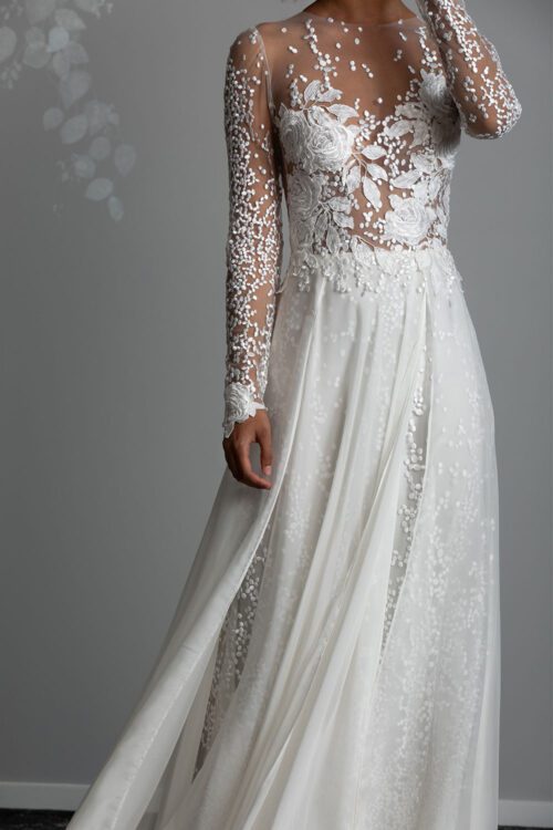 Rose Wedding Dress from Vinka Design. The front detail of the gown has a fitted tulle-based bodice with Italian embroidered roses with a skirt that features the beautiful spotted embroidery and flowing silk chiffon. Close up of embroidered rose and spotted lace bodice with silk chiffon skirt