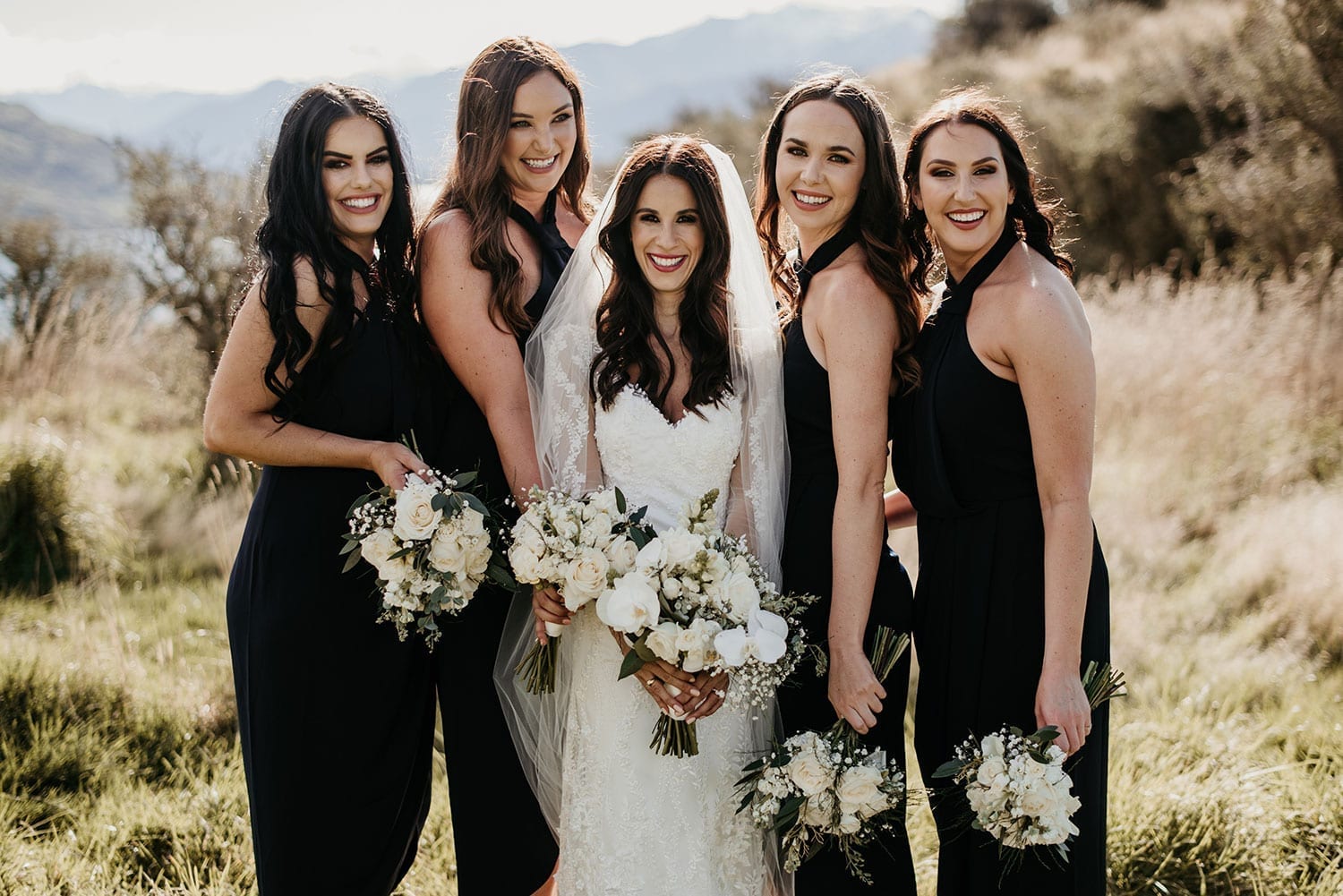 Vinka Design Features Real Weddings - Bride in custom made gown with bridesmaids in front of remarkables mountains