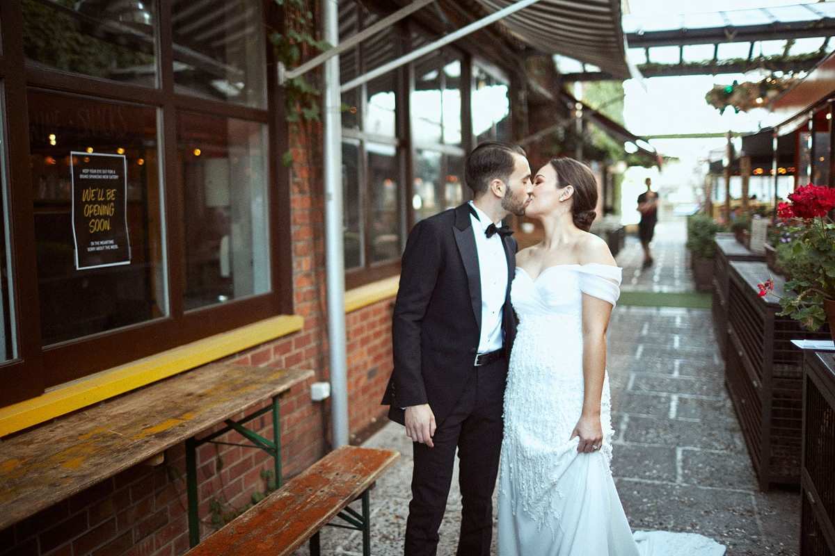 Vinka Design Features Real Weddings - bride in custom made gown. Bride and groom kiss