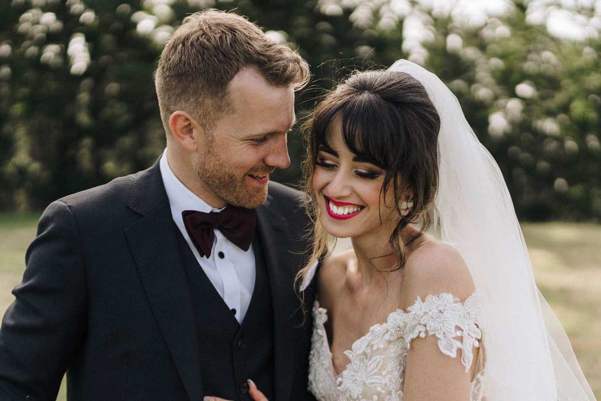 Vinka Design Features Real Weddings - bride in custom made gown. Bride and groom smile