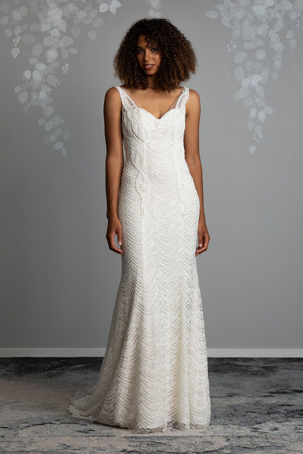 Juliette Wedding Dress from Vinka Design. Flattering stretch fitted lace wedding dress with beautiful ivory rich beading. Structured bodice provides support while remaining effortless to wear. Full length view of dress with structured bodice of ivory beaded lace over a champagne base