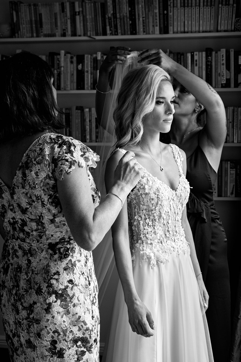 Bride wearing bespoke gown made of silk chiffon with delicate flower lace bodice by Vinka bridal designer Auckland - black and white getting ready