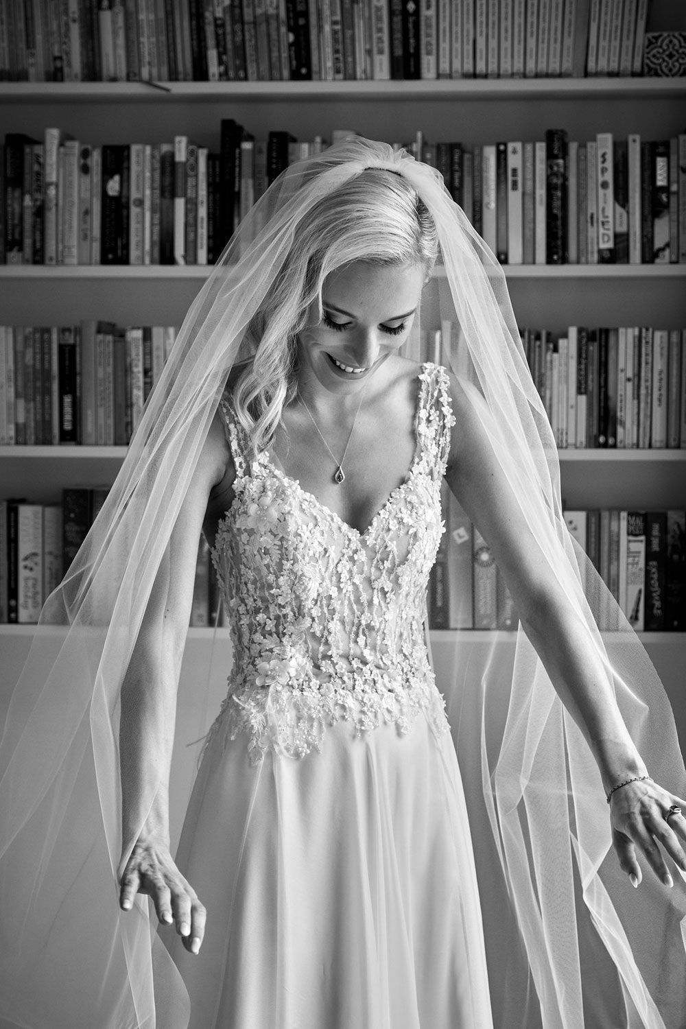 Bride wearing bespoke gown made of silk chiffon with delicate flower lace bodice by Vinka bridal designer Auckland - black and white with veil on