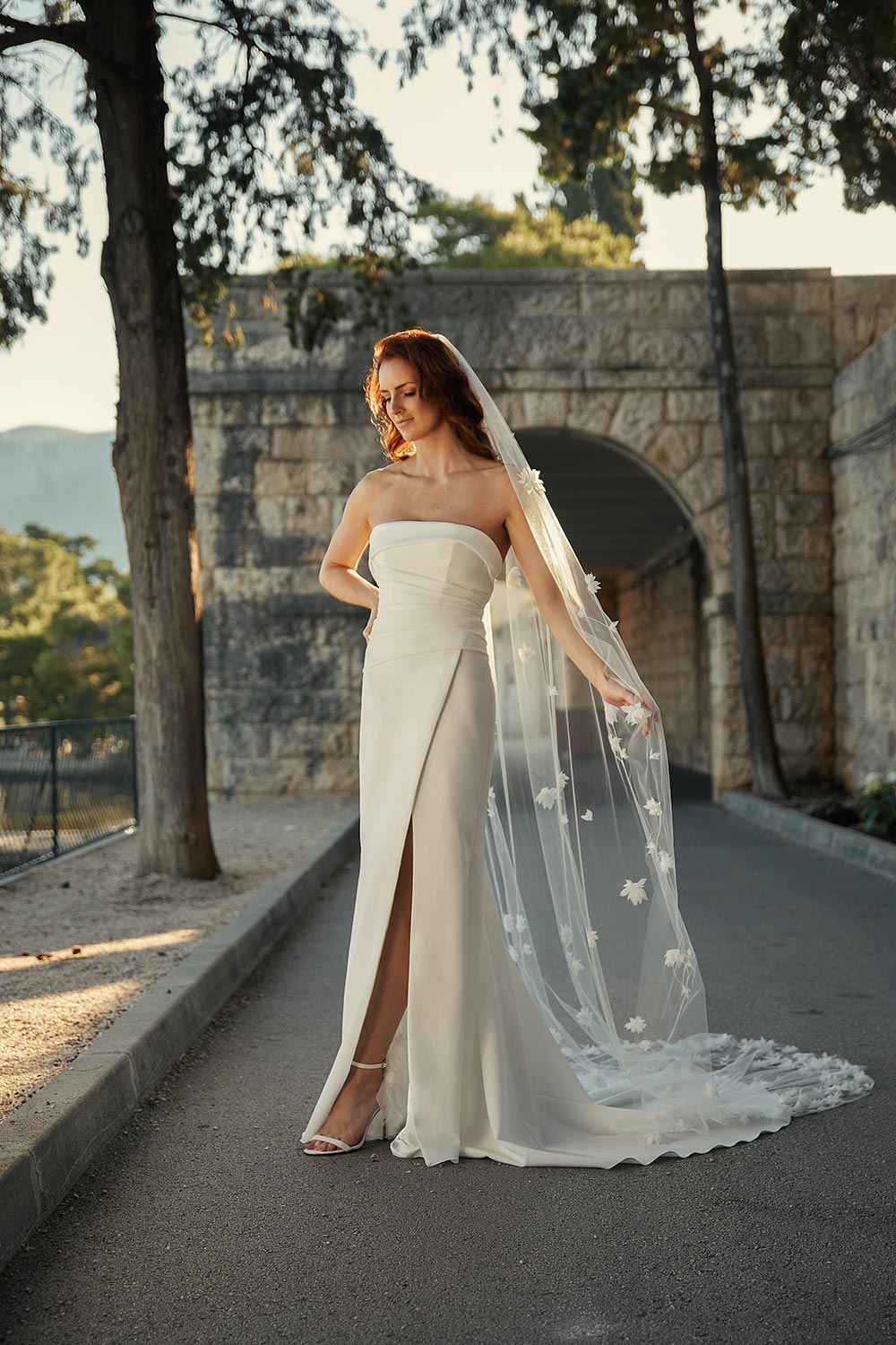 Mara, a minimalist bridal gown with stunning silhouette. Strapless wedding dress in heavyweight Japanese stretch polyester with a seductive split.. Vinka Design.
