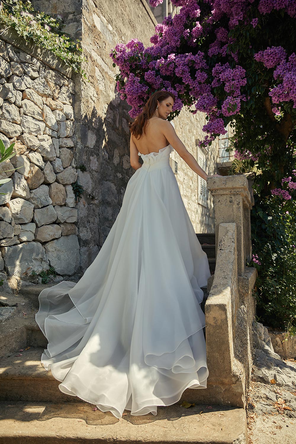 Rosana - bridal gown that embodies timeless elegance. Features satin organza, a strapless bodice, sweeping train, and hand-crafted rosette. By Vinka Design